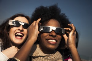 Group of friends looking to a solar eclipse
